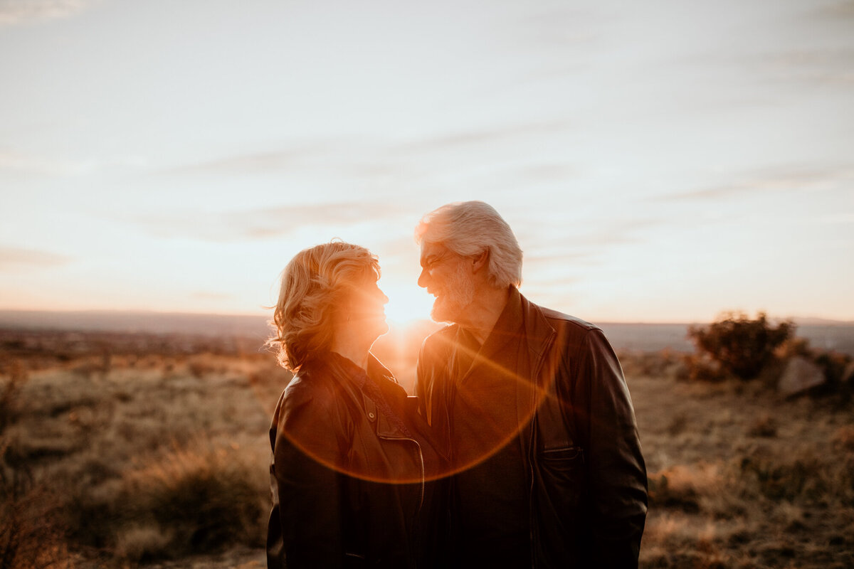 middle aged couple looking at each other with a sun flare