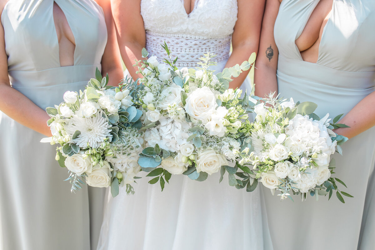Bride and two bridesmaids holding bouquets