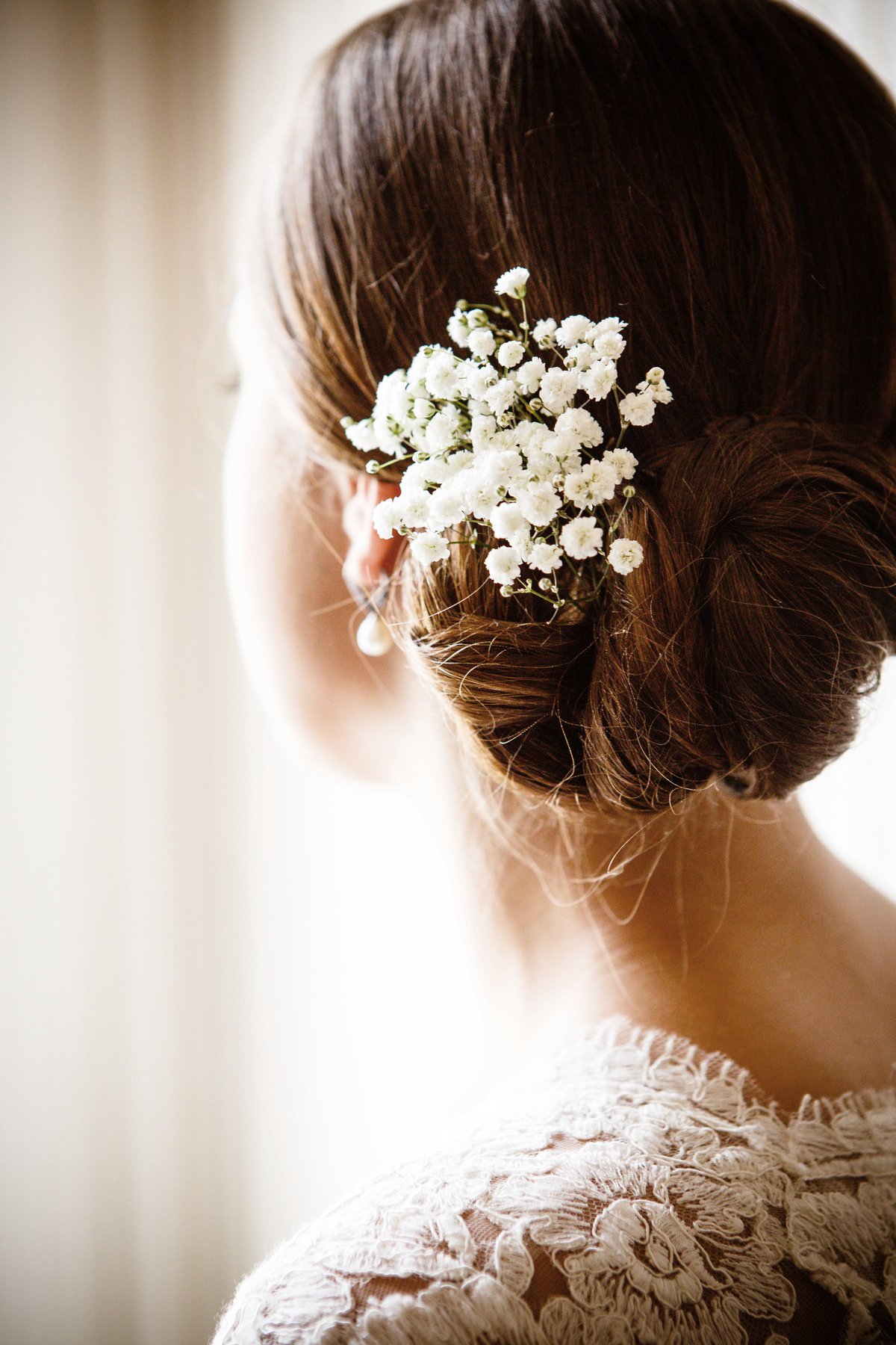 Detail photo of baby's breath in bride's hair at The Ezell House in Mobile, Alabama.