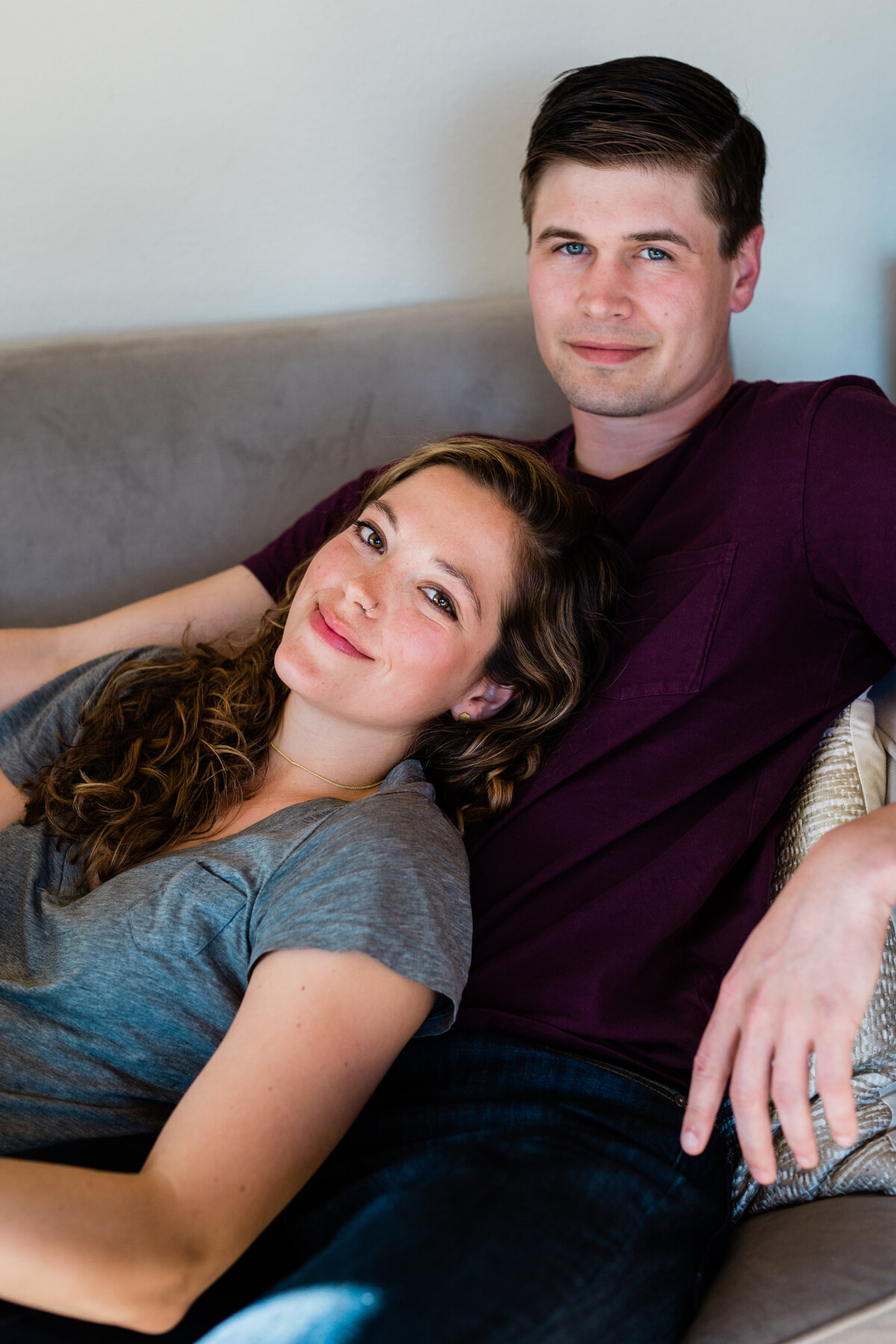 A photographer and her husband hanging out on the couch.