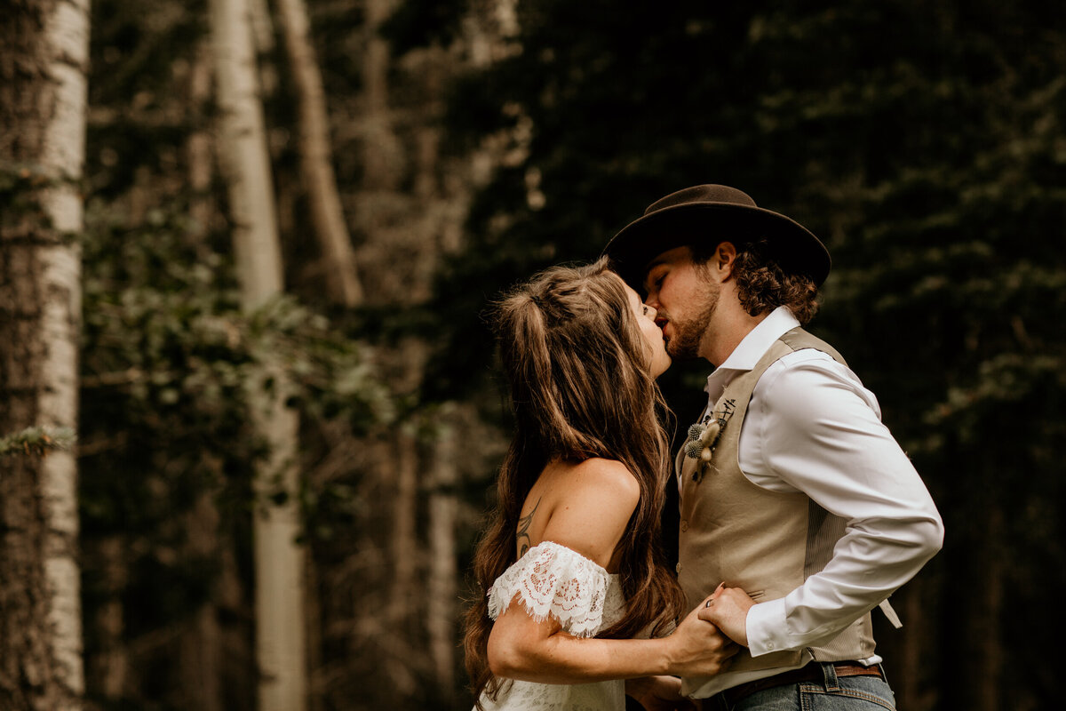 bride and grooms first kiss at New Mexico mountain top ceremony
