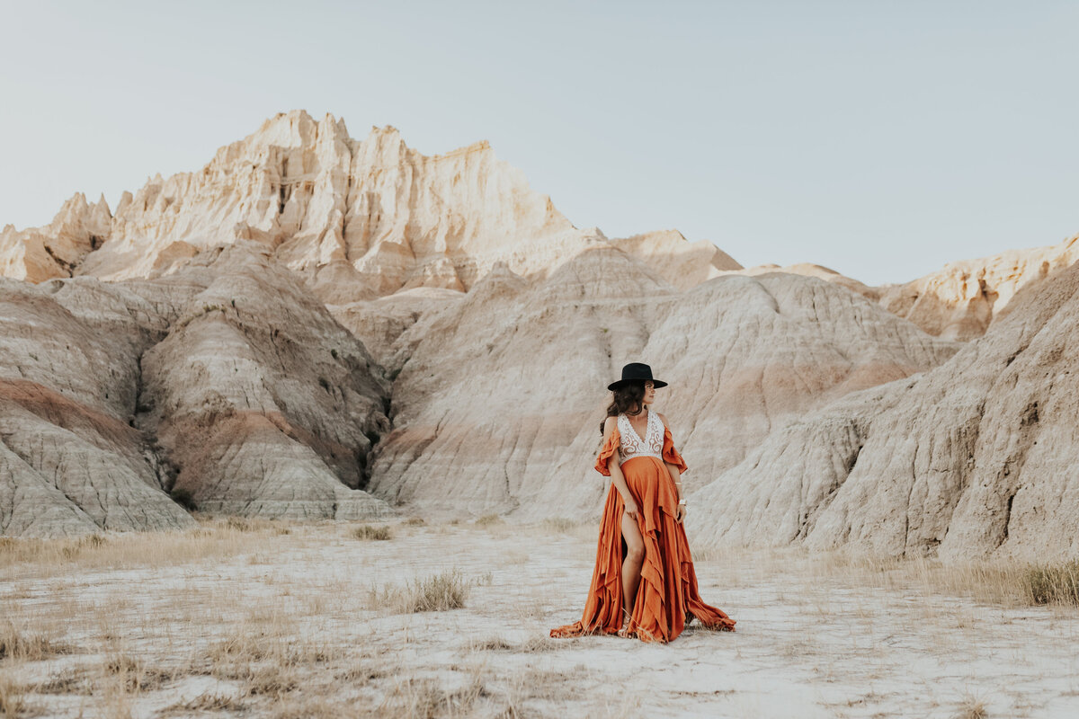 woman stands in front of mountain