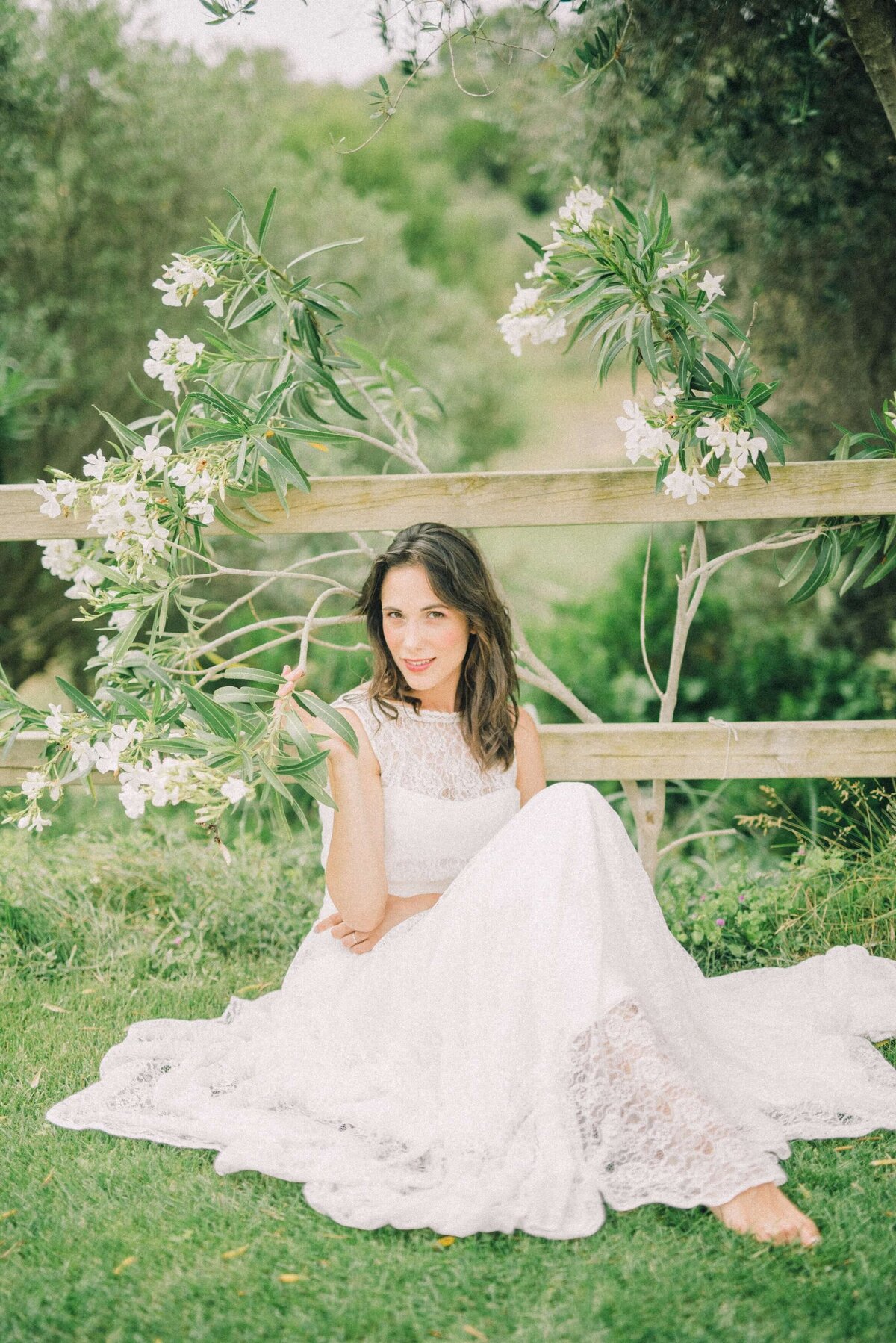 woman-sitting-on-grass-in-white-dress