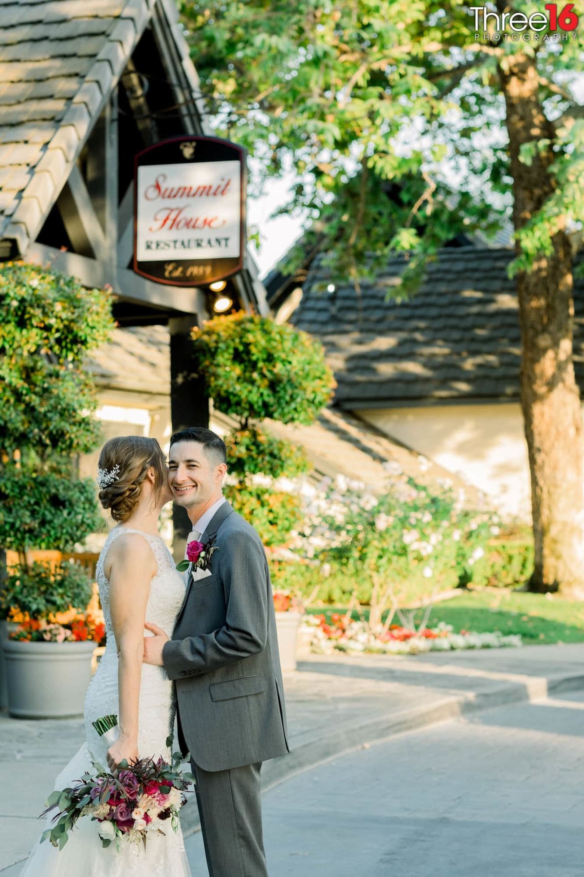 Bride and Groom embrace outside the Summit House Restaurant