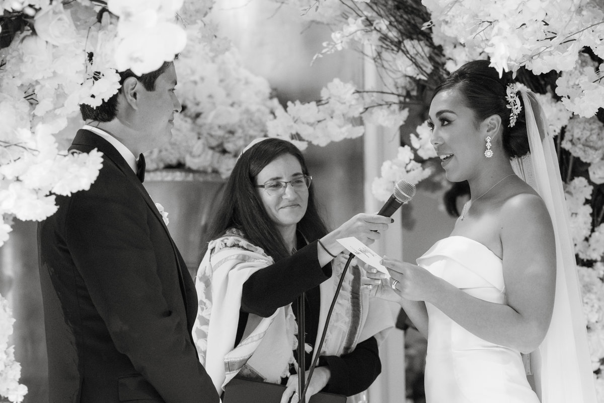 black and white photo of bride and groom during ceremony at The Garden City Hotel