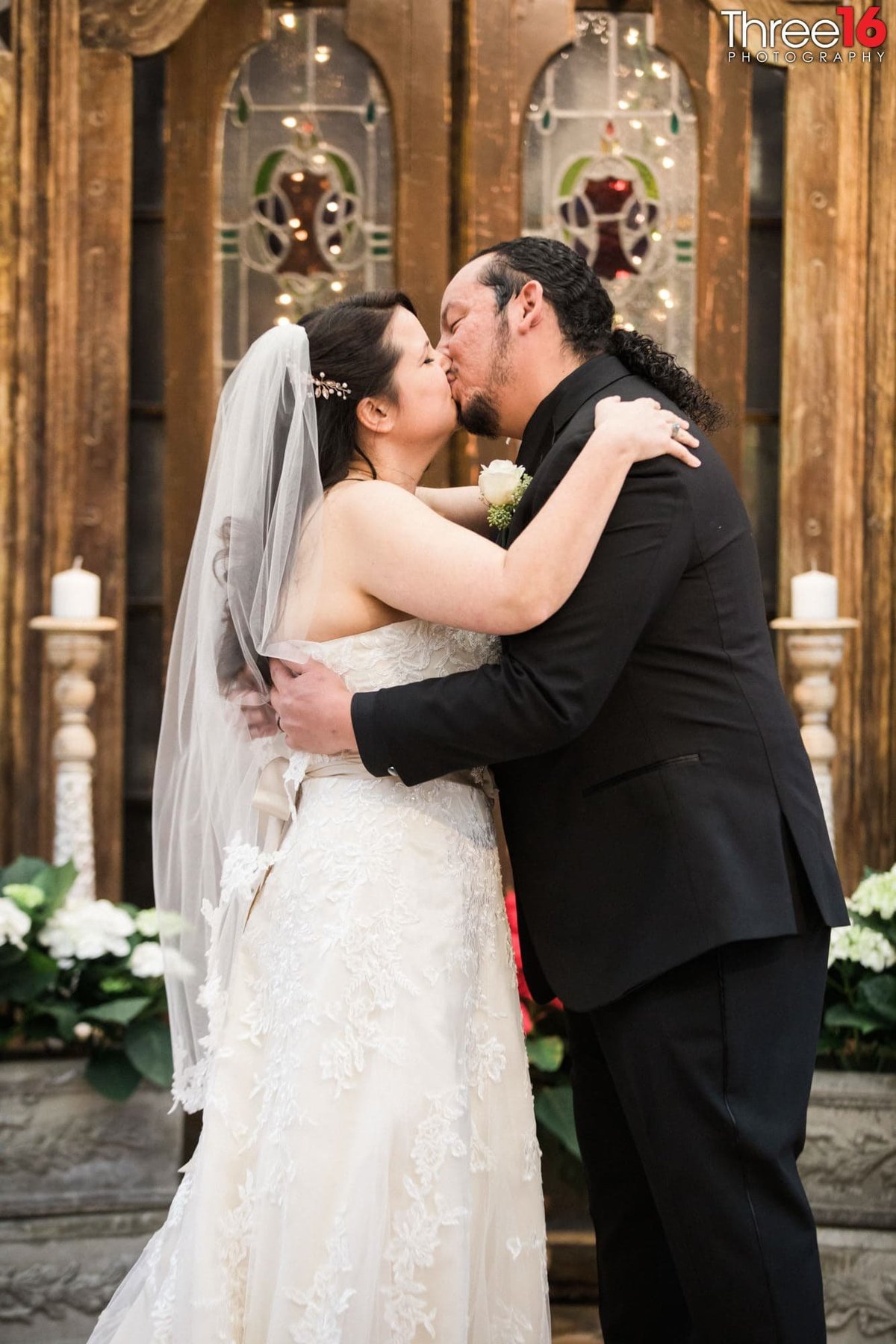 Newly married couple share their first kiss at the altar