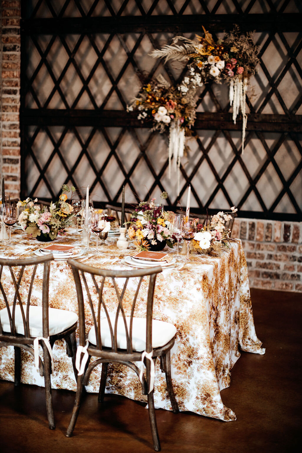 Iron Manor's Banquet Table with Arrangements and Taper Candles