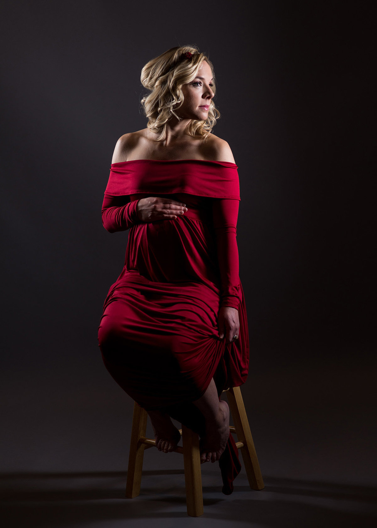 maternity pictures in red gown in studio in michigan