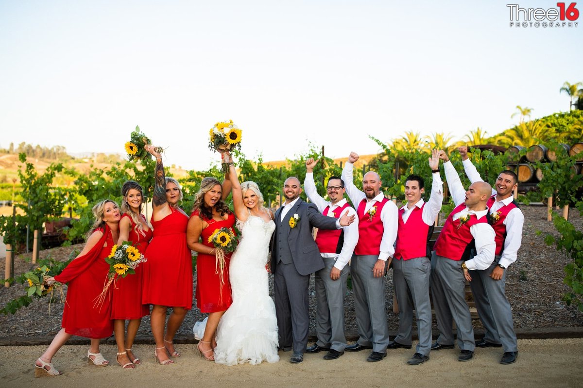 Bride and Groom cheer along with their bridal party