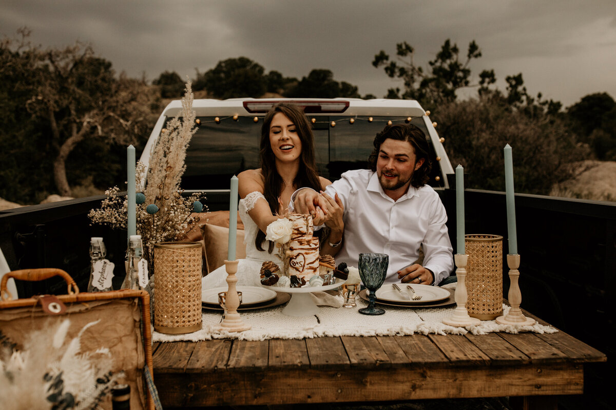 newlyweds having a picnic in their truck bed in New Mexico