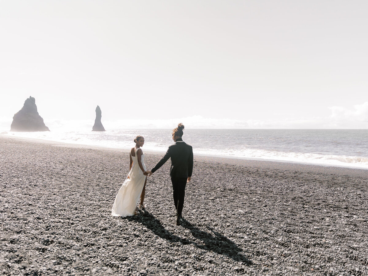 Bride and groom walking on a beach