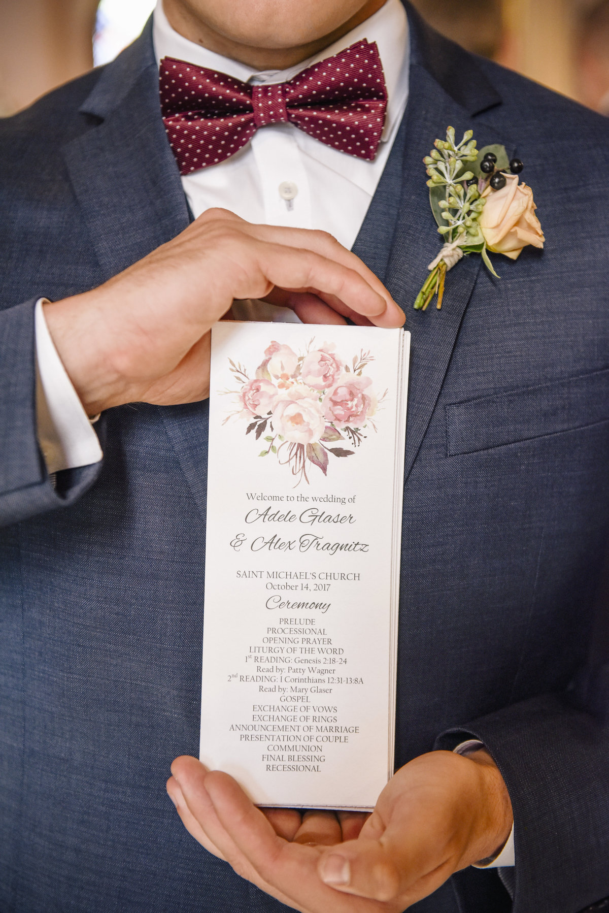 groomsman holding program for wedding ceremony
