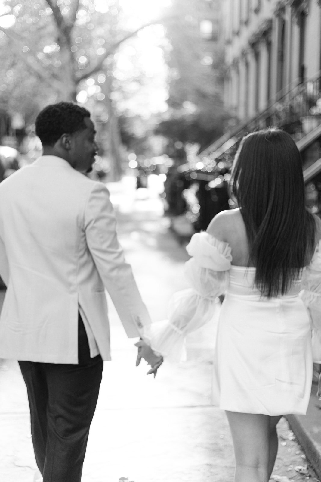 Couple walking hand in hand down brooklyn street