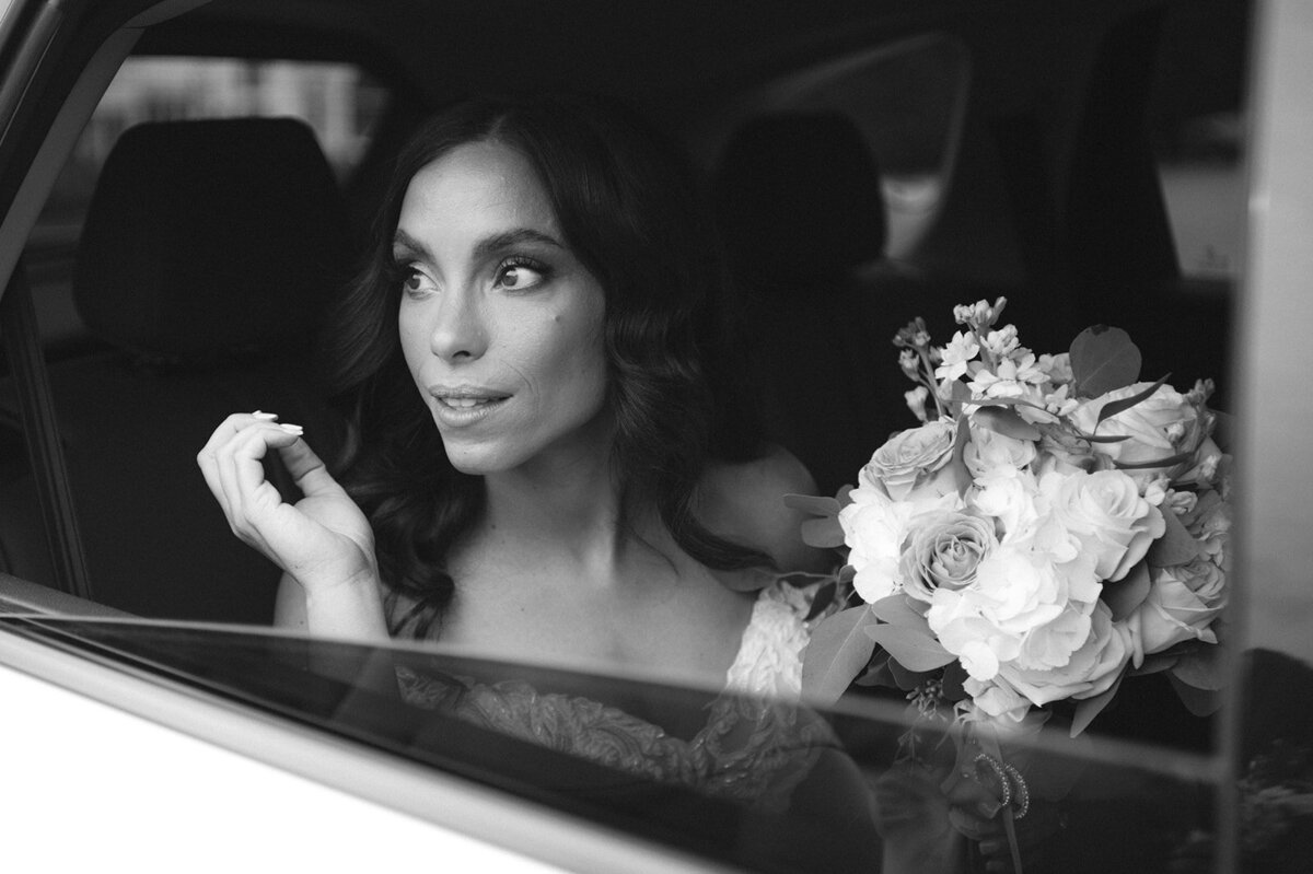 bride looks outside of window in limo at her ct wedding cait fletcher photography