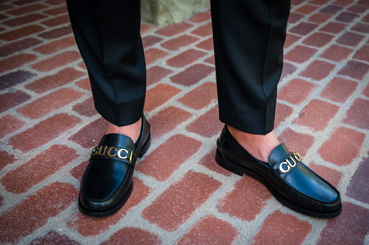 A close up shot of a groom's Gucci shoes.