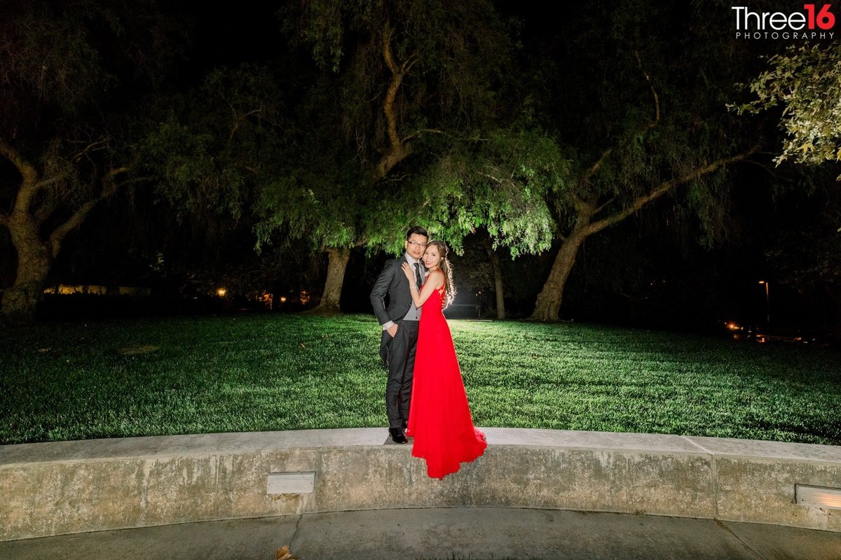 Bride and Groom pose for the photographer for night photos