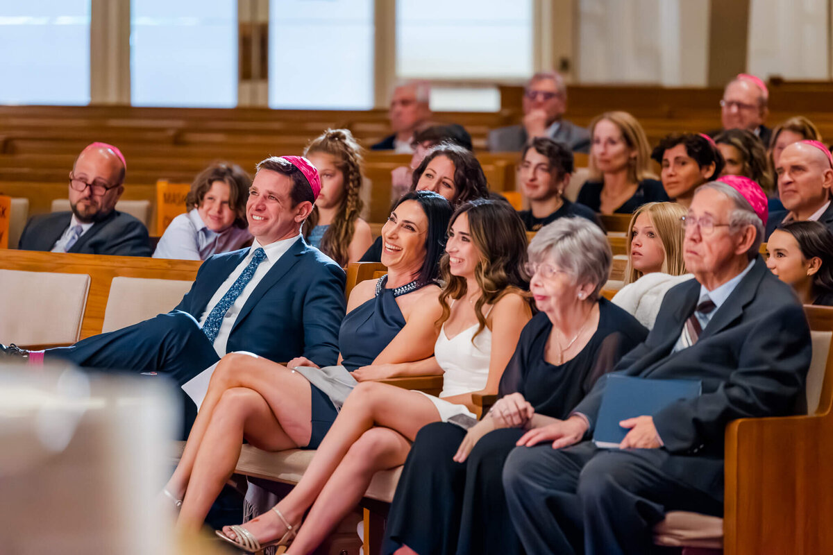 A family in the front row laughs during the speech at a bat mitzvah