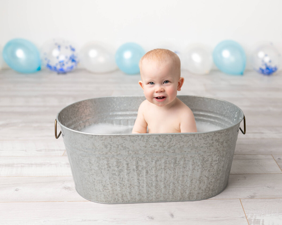 picture of boy in galvanized tub, after his cake smash session