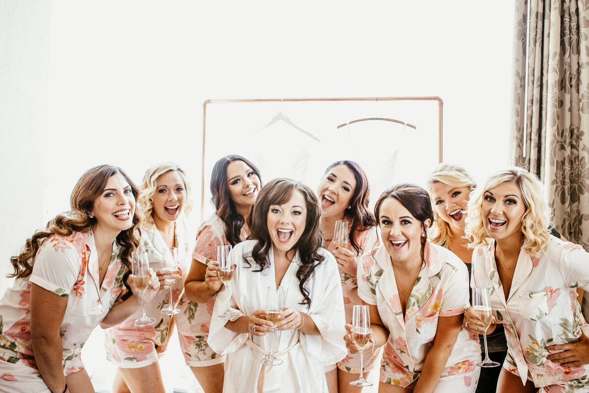 Bridal party getting ready for wedding with champagne in Buffalo, New York