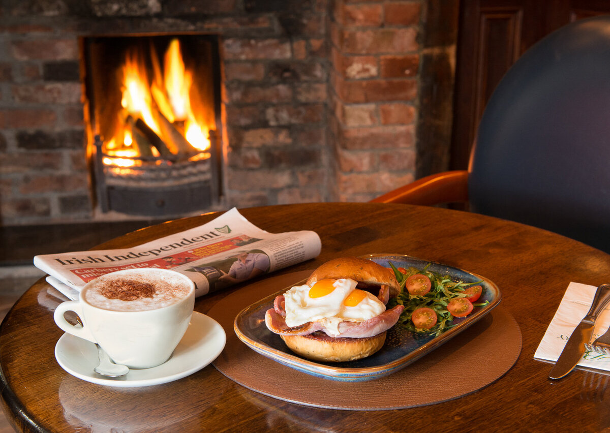 Egg and bacon bap with coffee by the fire