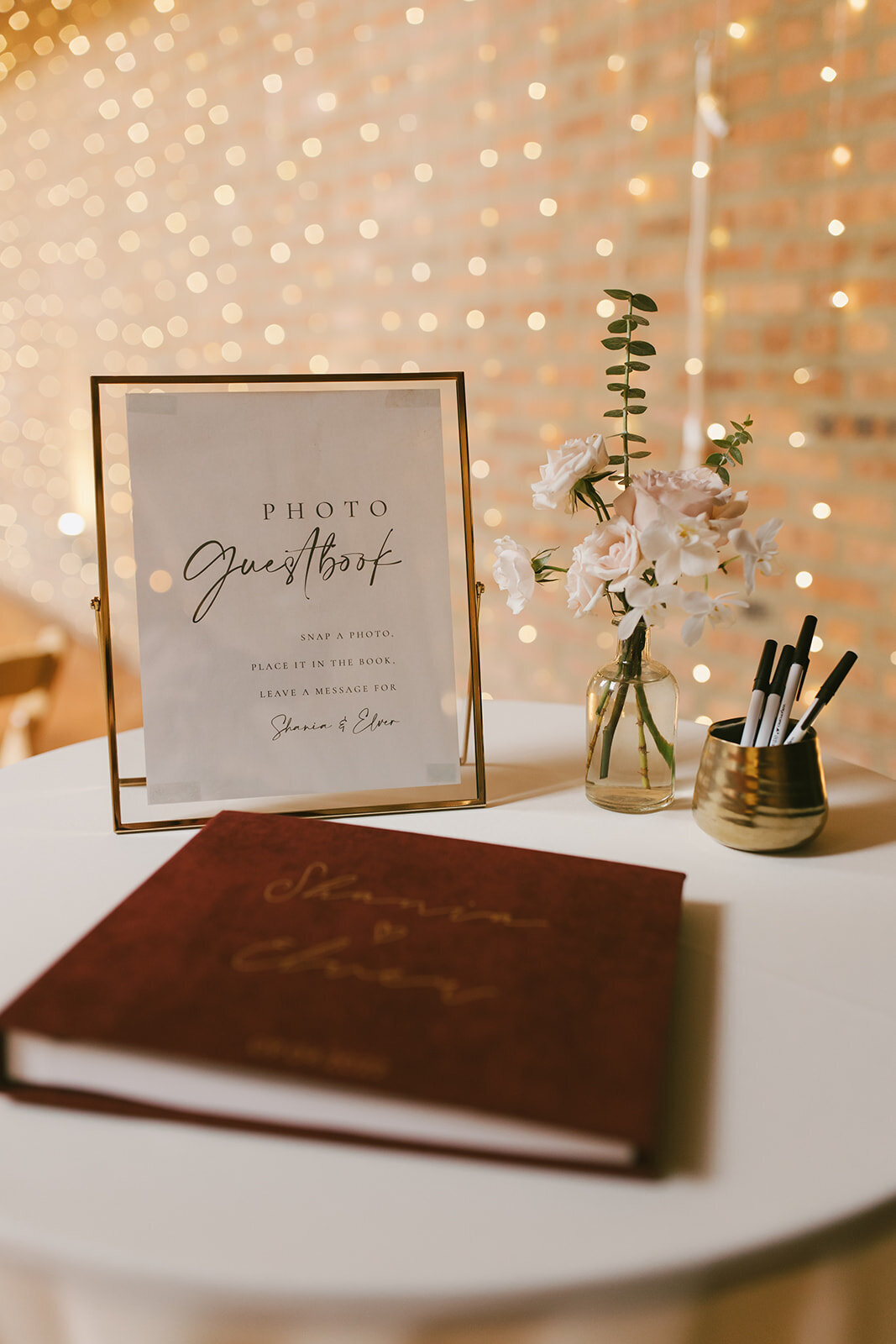 Guestbook table at Loft on Lake Chicago wedding with romantic twinkle lights in background.