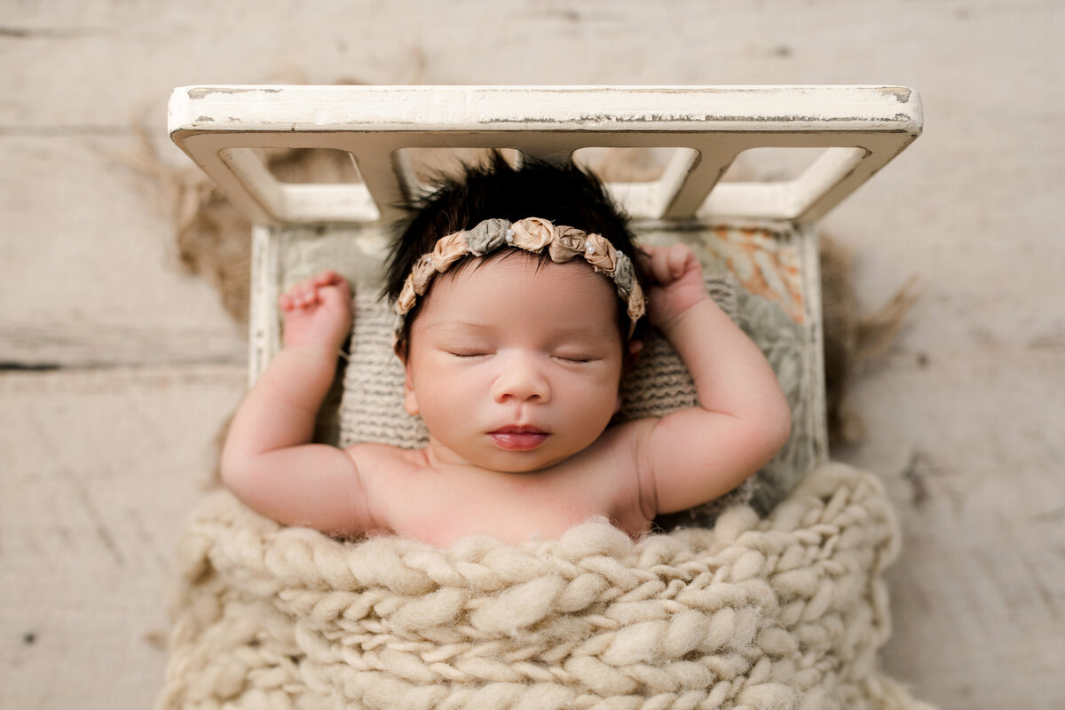 newborn baby girl in a small bed asleep trussville alabama photography lane weichman photography