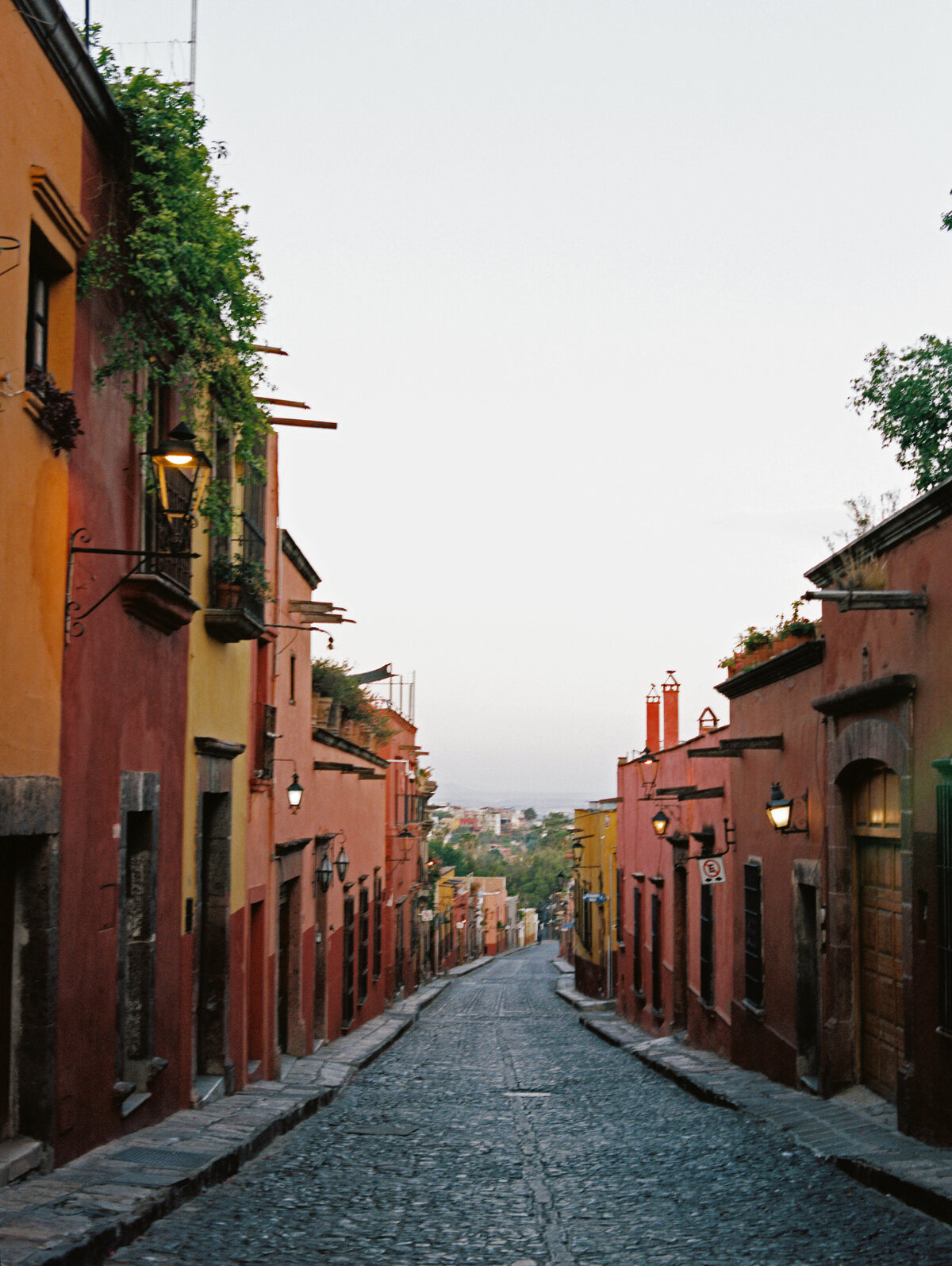 cobblestone street with colorful buildings in san miguel de allende