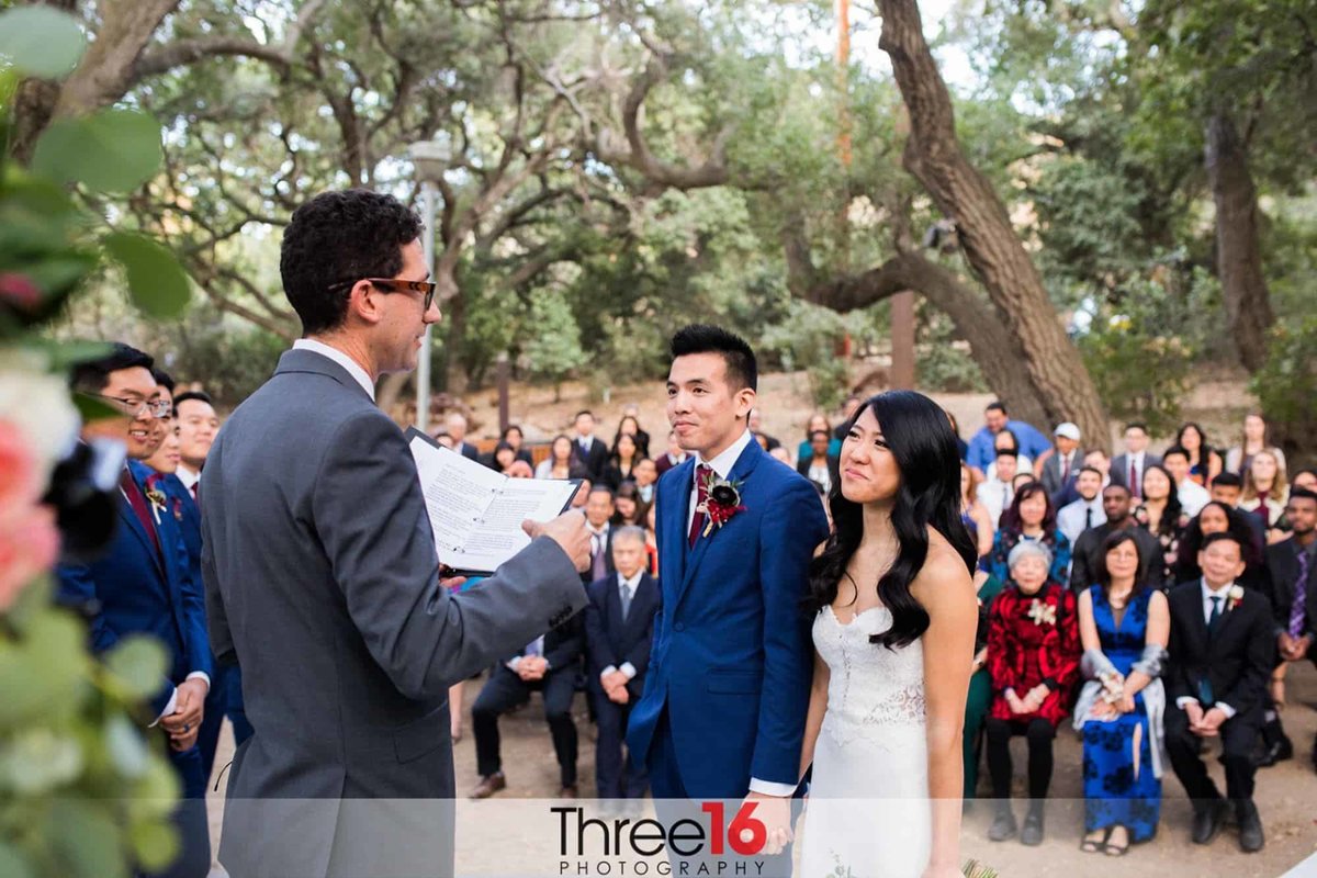 Bride and Groom listen to the officiant during their wedding ceremony