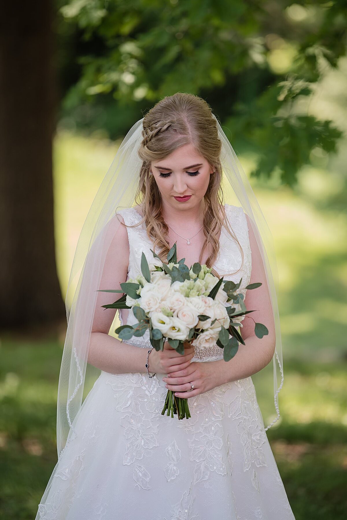 bride looking down at flowers