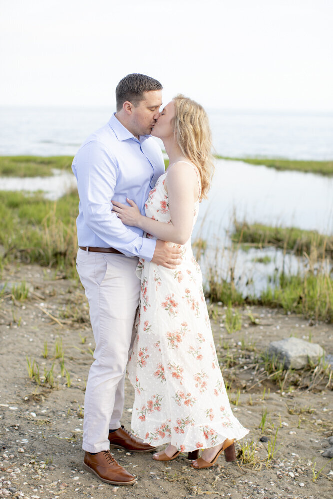 couple kisses on the beach, Southport engagement session by Rachel Girouard