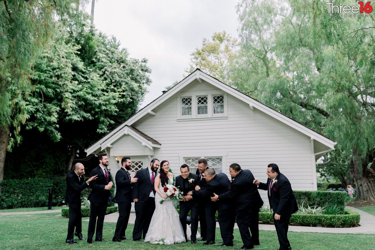 Groomsmen share a laugh with the Bride and Groom