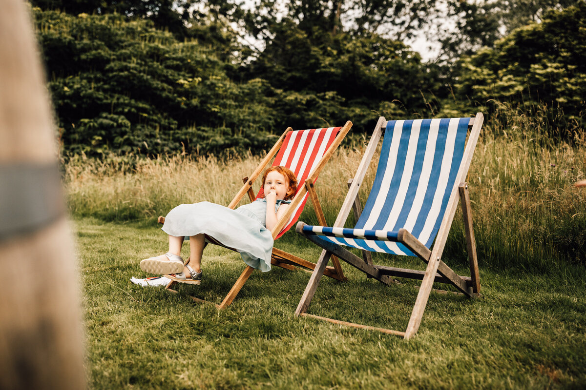 Child relaxing after wedding ceremony in beach chair