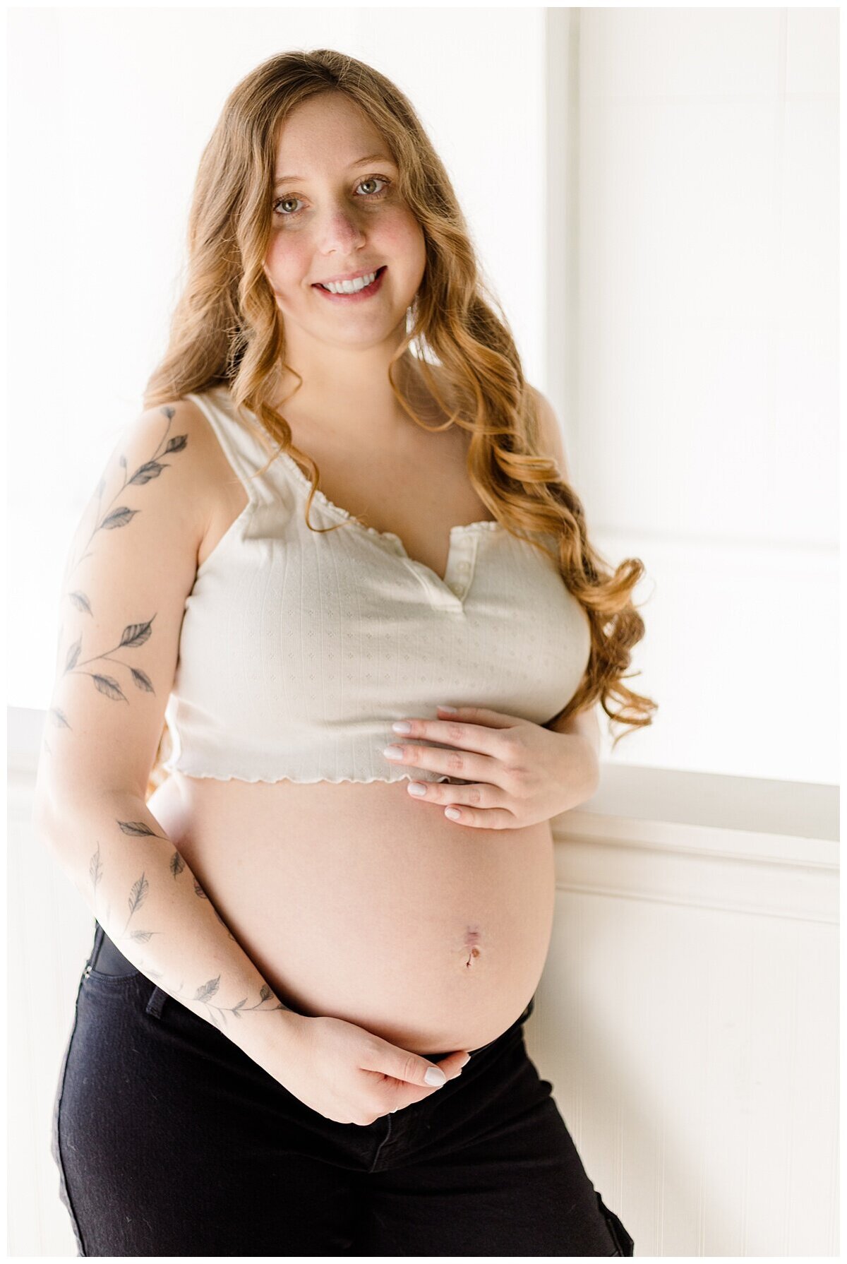 Mom is holding her baby belly during a studio Maternity Session in Wexford PA 