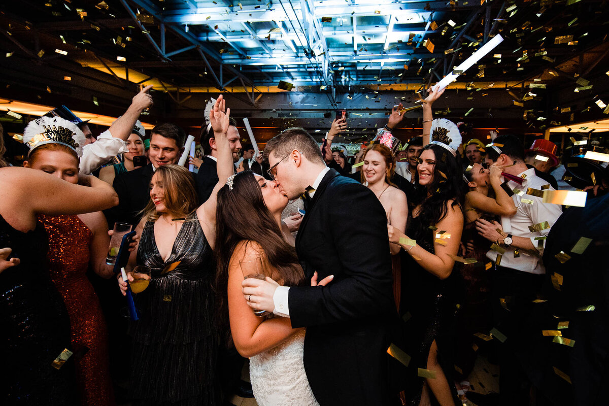 Bride and groom kiss at midnight during their wedding on NYE at the Kimmel Center Philadelphia