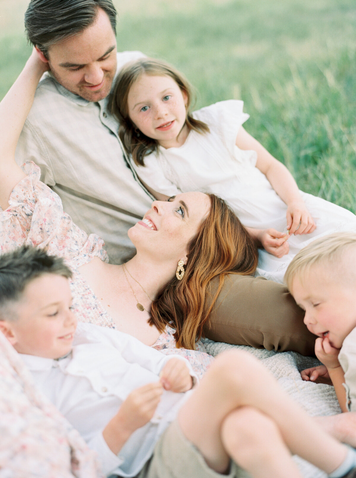 Family laying together on the grass photo by Chelsea Sliwa Photography