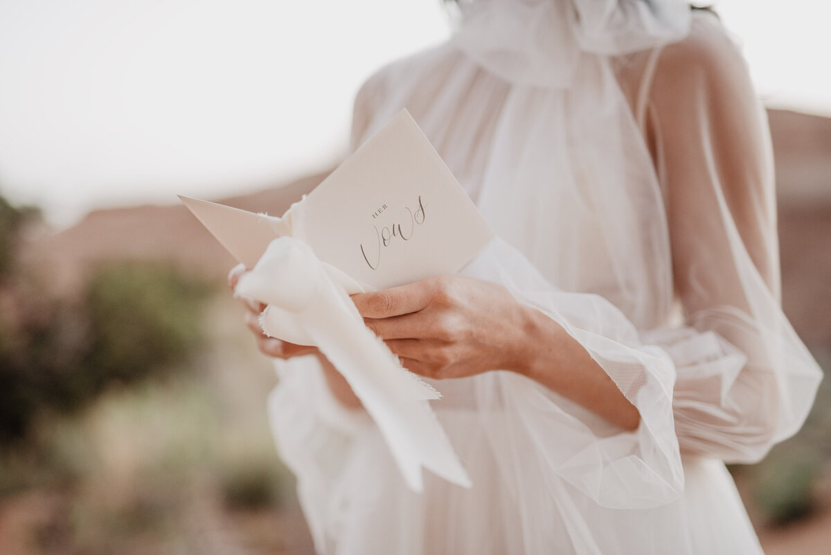 Utah elopement photographer captures bride holding vow book