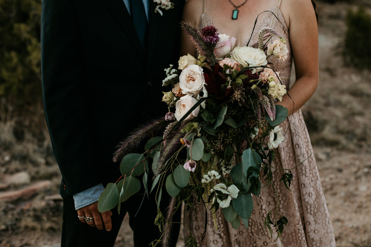 eloping couple holding bouquet