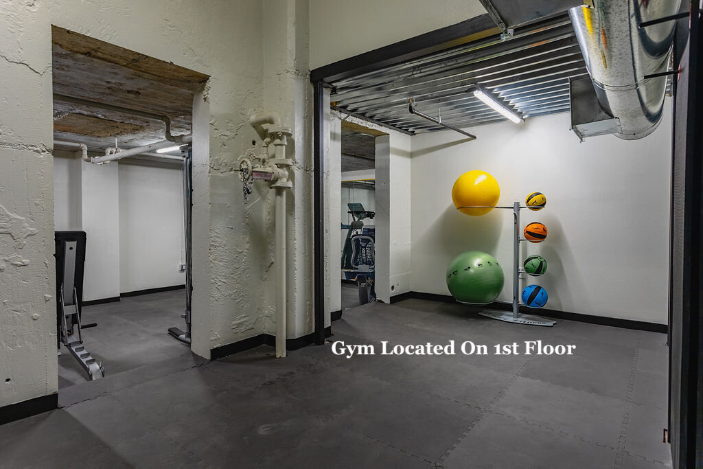 Exercise balls and exercise machines in the first floor gym of this one-bedroom, one-bathroom vintage industrial condo with Smart TV, free Wi-Fi, and washer/dryer located in downtown Waco, TX.