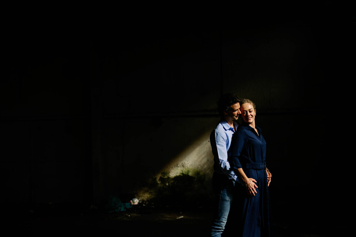 A couple stood in a shaft of light during their Pre wedding shoot in York