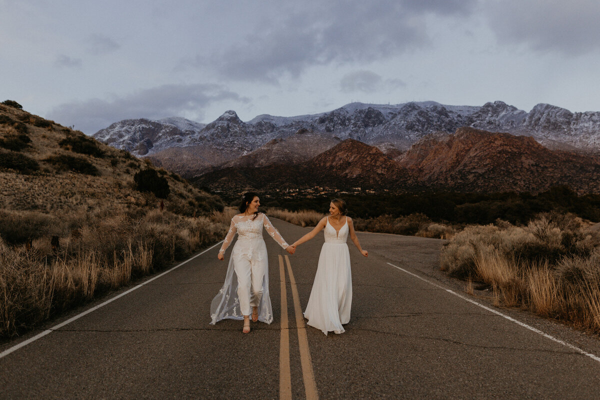 two brides walking together at the Sandia foothills in Albuquerque, New Mexico