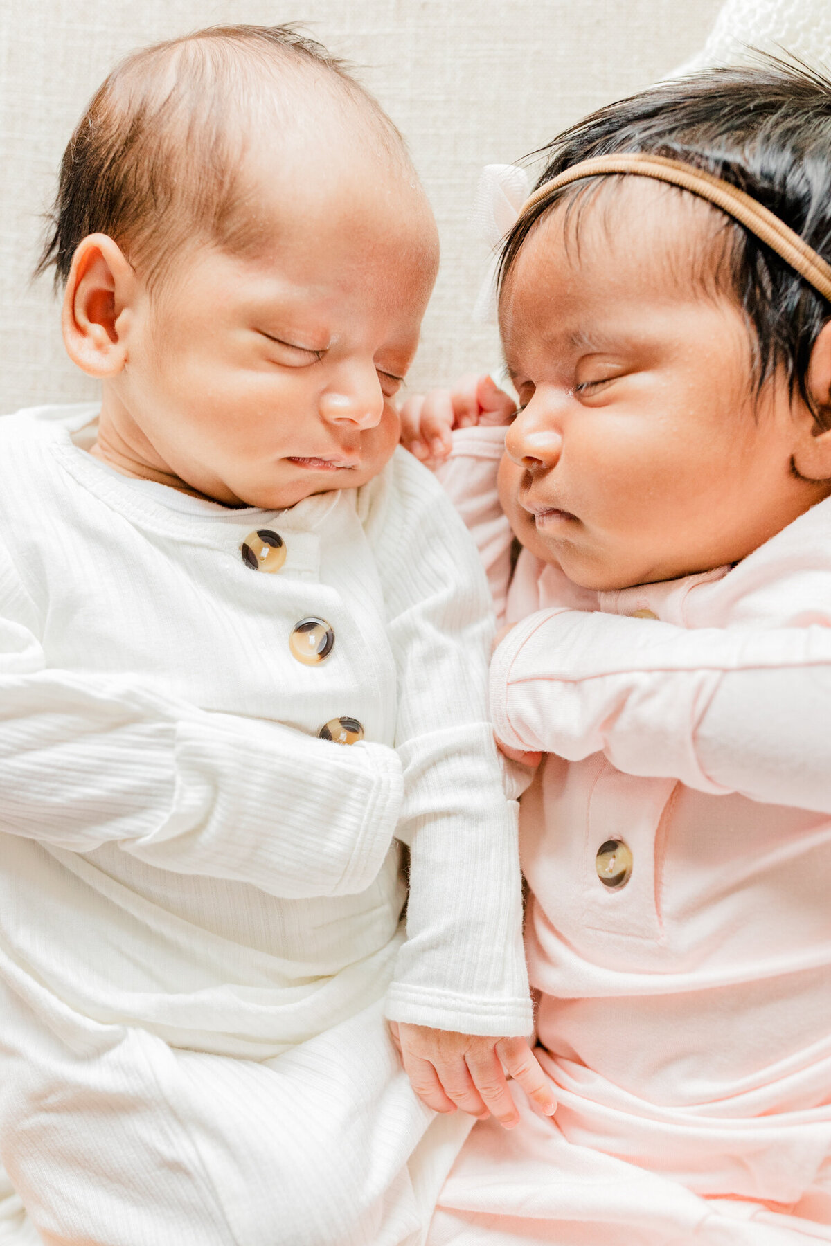 Twin sleeping newborns lying side by side in Boston Newborn Photography session