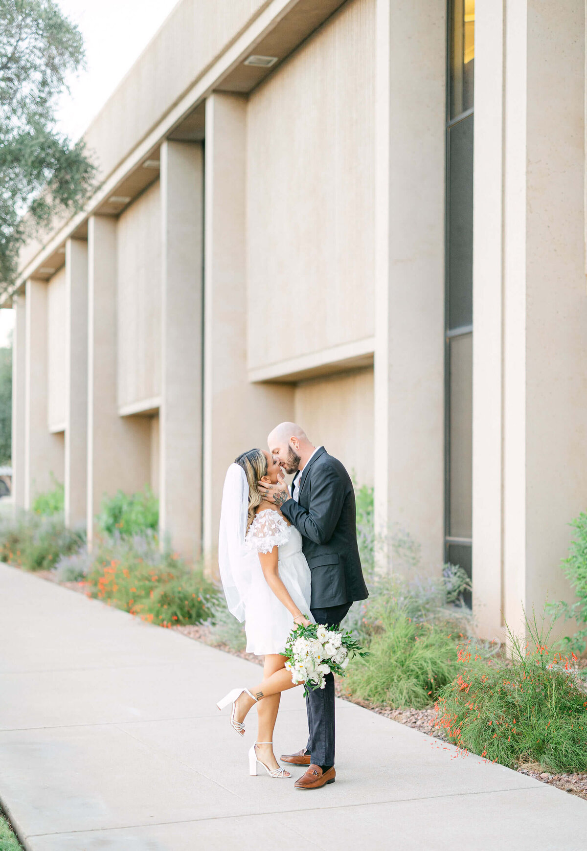The bride and groom share a tender kiss during their downtown Phoenix elopement photo session.