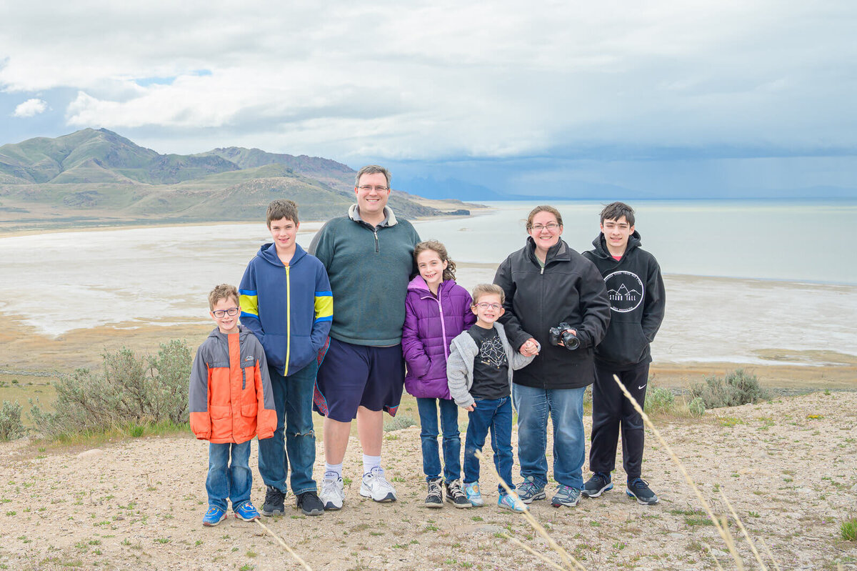 The Woodruff family smiling on a windy day at Antelope Island in the early spring