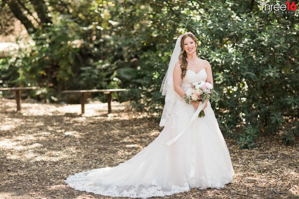 Bride poses with her dress train fanned out