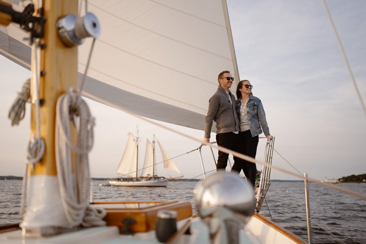 Couple takes romantic photos on a sailboat in Maine