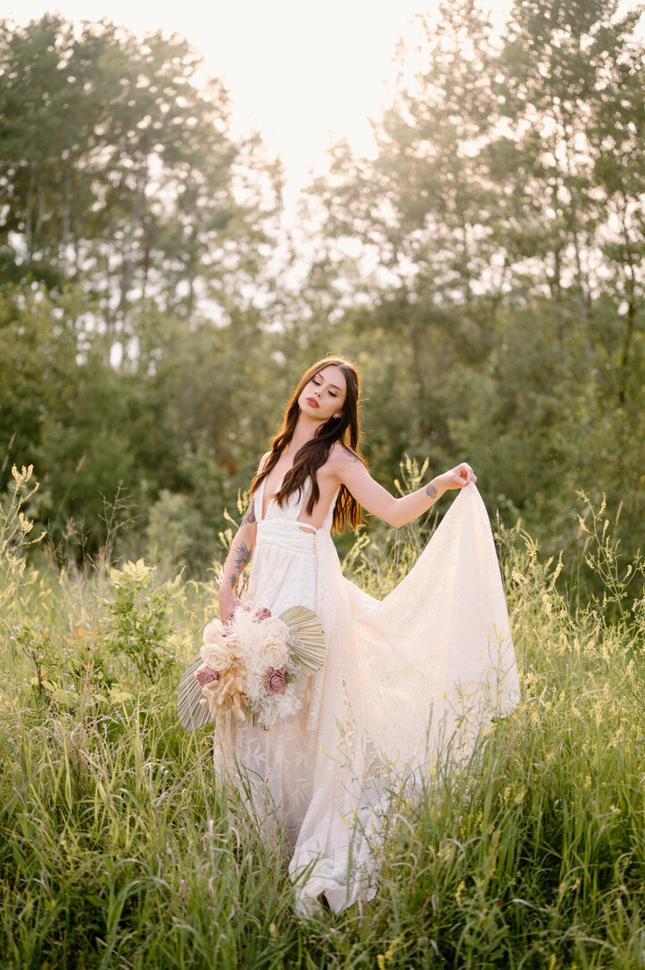 Bride gracefully walking through tall grasses