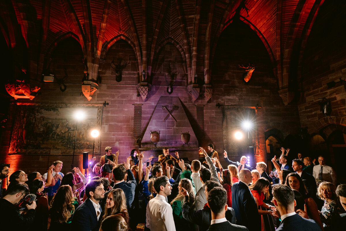 a full dance floor at peckforton castle wedding