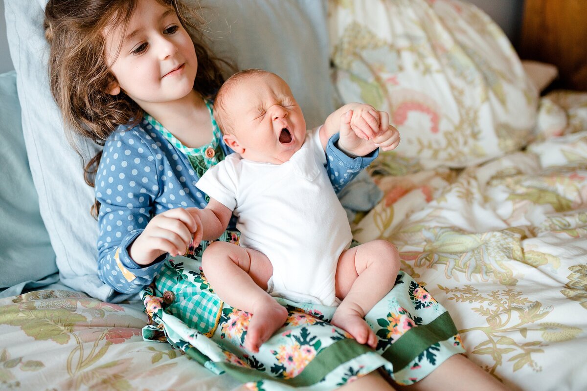 A sister with her baby brother during an in-home newborn session in Berea KY.