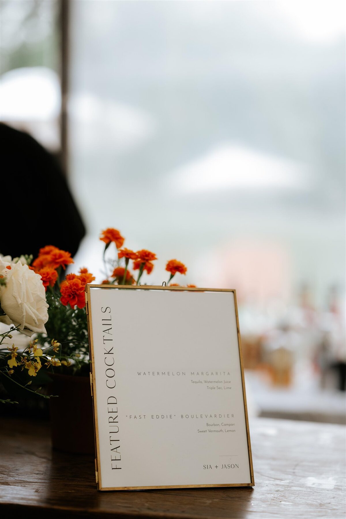 Signature Cocktail SIgn in a gold frame on a wood bar with flowers at Ankony Carriage House in the Hudson Valley