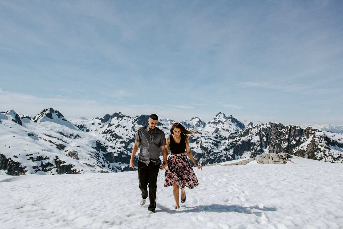 Couple walking on mountaintop after proposal